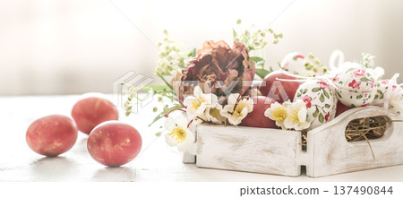 Easter background with a basket and red eggs with flowers 137490844