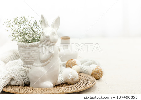 Easter composition with a ceramic hare and eggs. 137490855