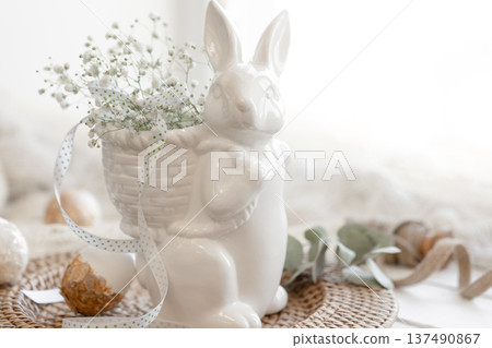 Easter composition with a ceramic hare and gypsophila flowers. Easter composition with a ceramic hare and gypsophila flowers. 137490867