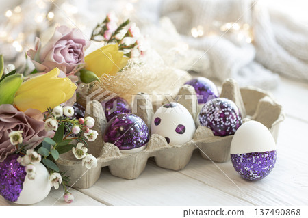 Easter composition with decorative eggs and flowers, close-up. Easter composition with decorative eggs and flowers, close-up. 137490868