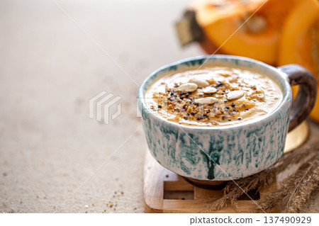 Close up shot of pumpkin soup in ceramic bowl. 137490929