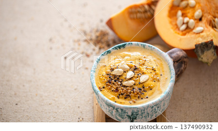 Close up shot of pumpkin soup in ceramic bowl copy space. 137490932