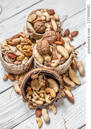 different nuts in a plate closeup 137490981