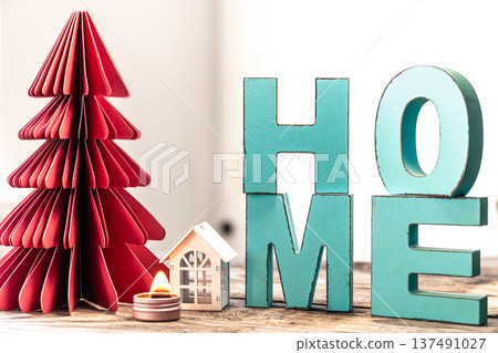 Cozy winter composition with decorative word home and paper christmas tree. 137491027