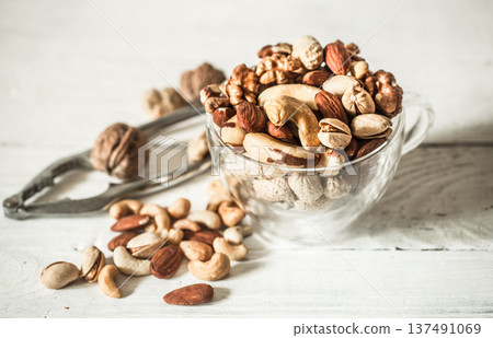 different nuts on wooden background 137491069