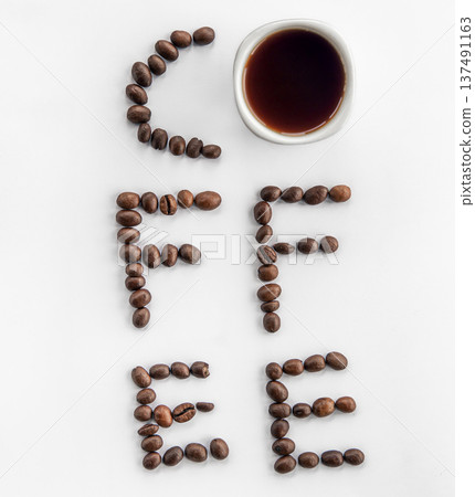 Cup of coffee and coffee beans make the word coffee, flat lay. 137491163