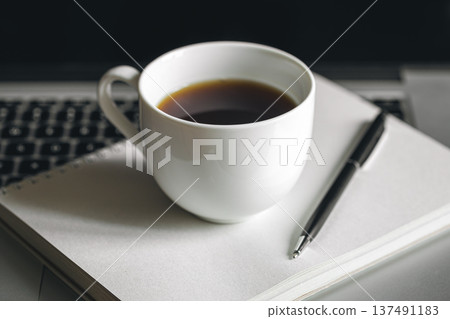 Cup of coffee, notepad and laptop, office work concept. Cup of coffee, notepad and laptop, office work concept. 137491183