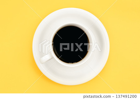 Cup of espresso coffee on a yellow background, top view. Cup of espresso coffee on a yellow background, top view. 137491200