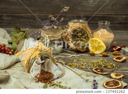 Cup of tea on wooden background with lemon and herbs Cup of tea on wooden background with lemon and herbs 137491262