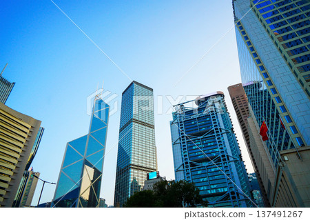Skyscrapers in bright glass exteriors sunlight on sunset. Modern facade office buildings Skyscrapers in bright glass exteriors sunlight on sunset. Modern facade office buildings 137491267