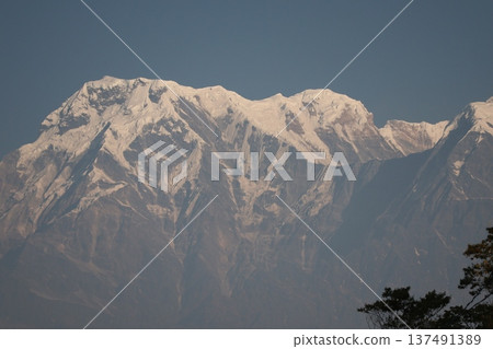 Close-up view of snow-capped Himalayan mountains against blue sky 137491389