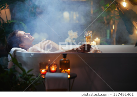 Woman Indulging in a Luxurious Champagne Bath 137491401