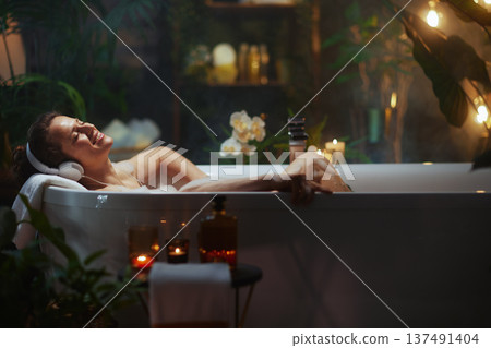 Peaceful Bath Time: Woman with Headphones 137491404