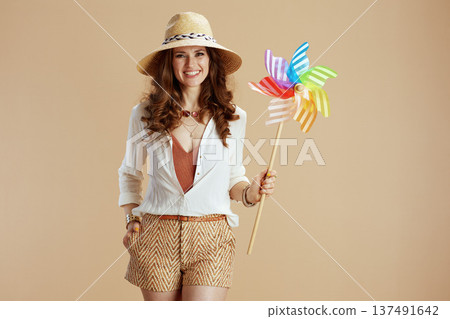 smiling elegant woman in blouse and shorts smiling elegant woman in blouse and shorts 137491642