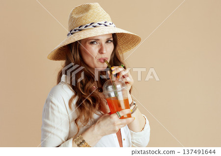 happy elegant woman in blouse and shorts against beige happy elegant woman in blouse and shorts against beige 137491644