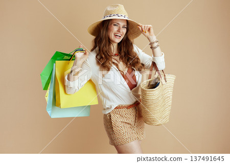 happy trendy woman in white blouse and shorts isolated on beige happy trendy woman in white blouse and shorts isolated on beige 137491645