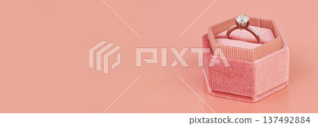 Banner with copy space. Luxury diamond ring in a pink gift box Banner with copy space. Luxury diamond ring in a pink gift box 137492884
