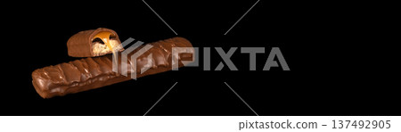 Banner with copy space. A chocolate bar with a caramel center is shown Banner with copy space. A chocolate bar with a caramel center is shown 137492905