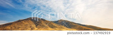 Banner with copy space. A mountain range with a valley in between Banner with copy space. A mountain range with a valley in between 137492919
