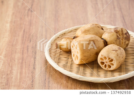 Raw lotus root (renkon) ingredients served on a bamboo colander Raw lotus root (renkon) ingredients served on a bamboo colander 137492938