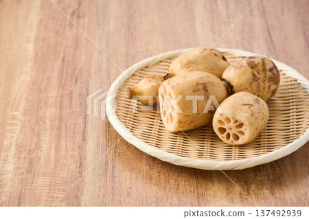 Raw lotus root (renkon) ingredients served on a bamboo colander Raw lotus root (renkon) ingredients served on a bamboo colander 137492939
