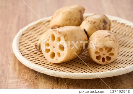 Raw lotus root (renkon) ingredients served on a bamboo colander Raw lotus root (renkon) ingredients served on a bamboo colander 137492948