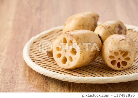 Raw lotus root (renkon) ingredients served on a bamboo colander Raw lotus root (renkon) ingredients served on a bamboo colander 137492950