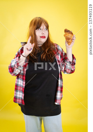 Young woman contemplating a croissant and thinking about a choice Young woman contemplating a croissant and thinking about a choice 137493119