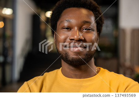 African American man portrait looking directly at camera smiling in coworking space 137493569