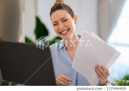 Young business woman having a video call and laughing 137494409