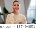 Young woman talking on the phone and smiling nicely 137494651