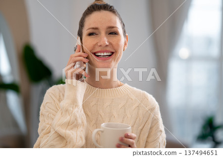 Young woman talking on the phone and smiling nicely 137494651