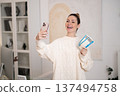 Woman with a phone in hands looking excited 137494758