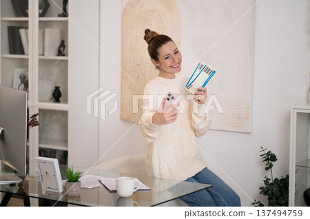 Woman with a phone in hands looking excited 137494759