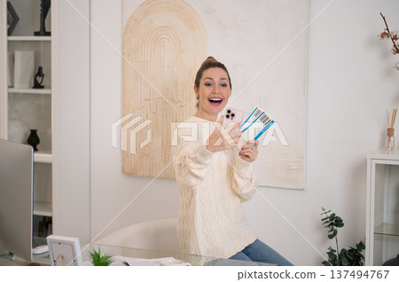 Woman with a phone in hands looking excited 137494767
