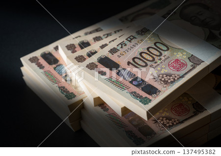 A stack of bills. A dark image. 137495382