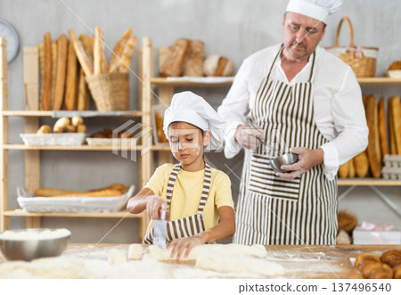 Dad and daughter cook croissants together, cut dough and have nice time 137496540