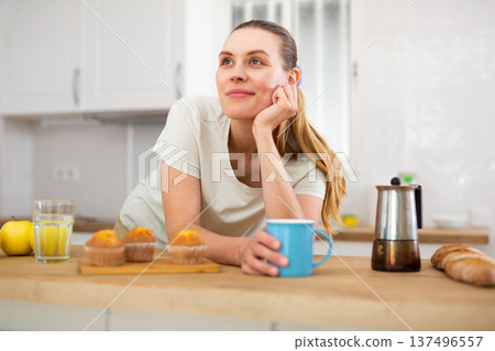 Cheerful woman drinking coffee in apartment 137496557
