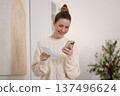 Woman reading a message on the phone and smiling 137496624