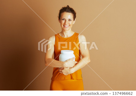 Smiling Woman Holding Supplement for Wellness Smiling Woman Holding Supplement for Wellness 137496662