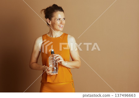 Smiling Woman with Water Bottle, Waist Up Smiling Woman with Water Bottle, Waist Up 137496663