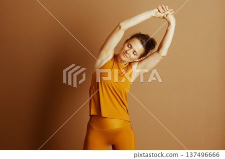 Serene Woman Performing Side Bend Stretch Serene Woman Performing Side Bend Stretch 137496666