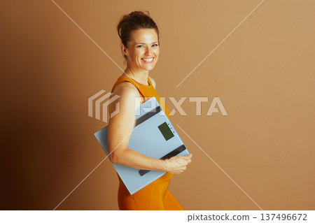 Active Woman Tracking Health with Scale Active Woman Tracking Health with Scale 137496672