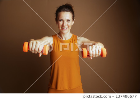 Empowering Fitness: Woman with Dumbbells Empowering Fitness: Woman with Dumbbells 137496677