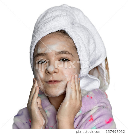 Young girl with towel on head applying facial cleanser and foam for skincare at home daily 137497032