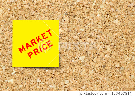 Yellow note paper with word market price on cork board background with copy space Yellow note paper with word market price on cork board background with copy space 137497814