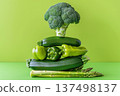 Healthy green vegetable stack featuring broccoli, peppers, zucchini and asparagus on bright lime background 137498137