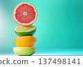 Vibrant citrus stack of halved fruits on a bright turquoise background 137498141
