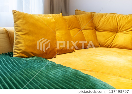 Bright yellow velvet sofa with matching pillows Bright yellow velvet sofa with matching pillows 137498797
