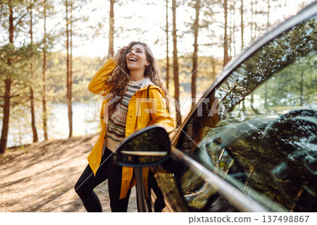Female driver enjoying freedom and beautiful nature. Concept of traveling by car, active lifestyle. Female driver enjoying freedom and beautiful nature. Concept of traveling by car, active lifestyle. 137498867
